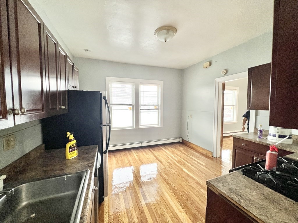 113 Ferry Street, Unit 2 Everett, MA 02149 - Photo 2 of 6 a kitchen with stainless steel appliances granite countertop a sink stove and refrigerator