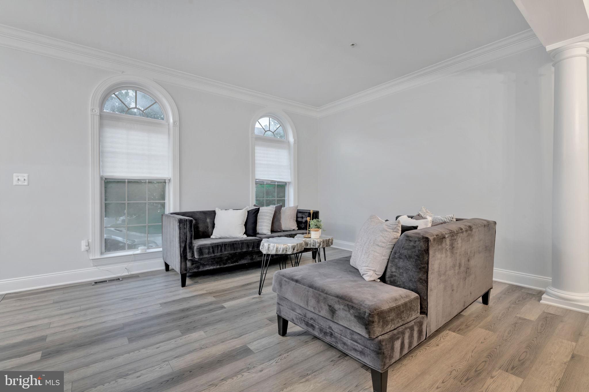 7619 Elmcrest Road Hanover, MD 21076 - Photo 13 of 35 a living room with furniture and a wooden floor
