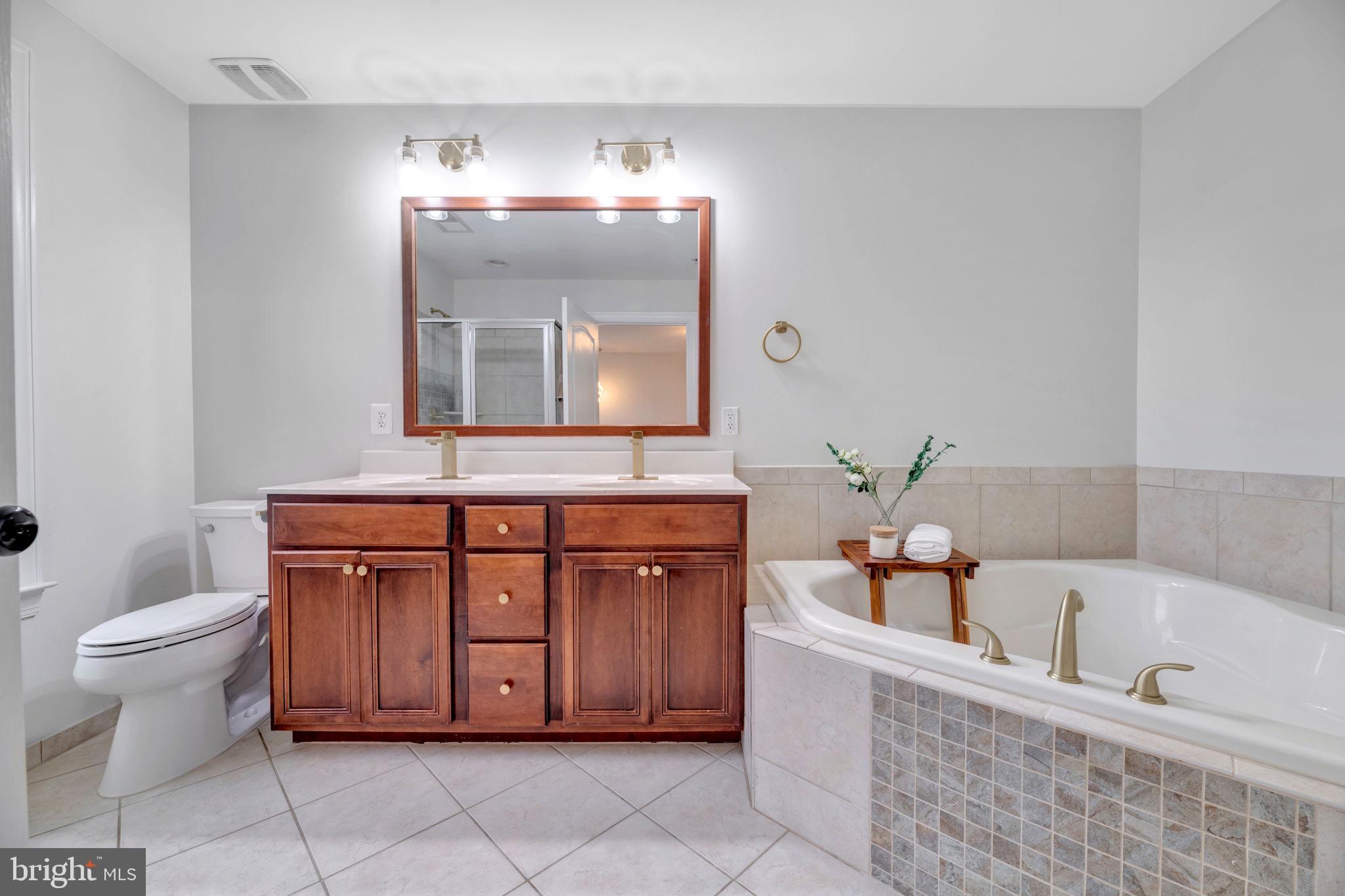 7619 Elmcrest Road Hanover, MD 21076 - Photo 17 of 35 a bathroom with a bathtub sink and toilet