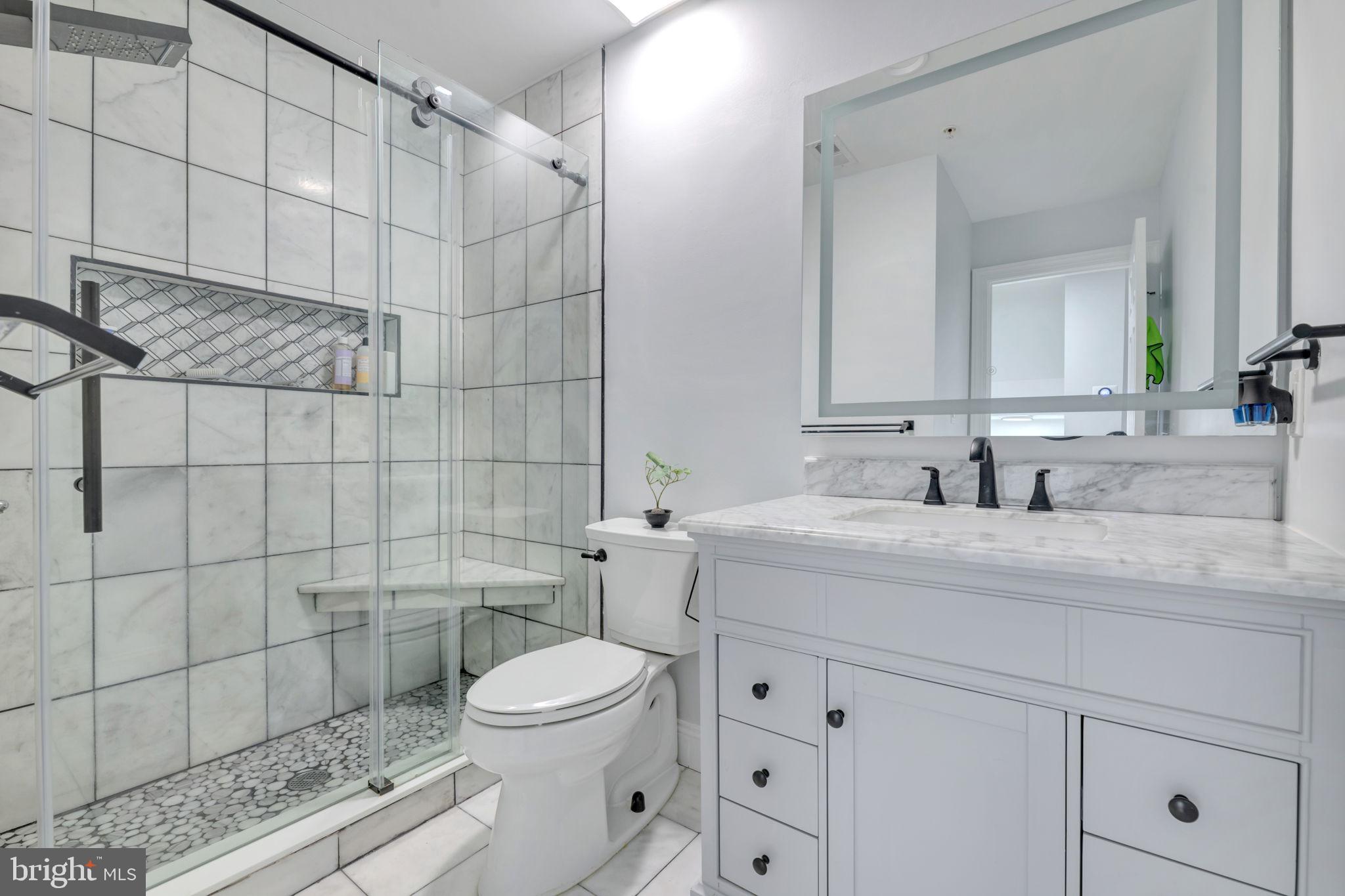 7619 Elmcrest Road Hanover, MD 21076 - Photo 20 of 35 a bathroom with a sink a toilet and shower