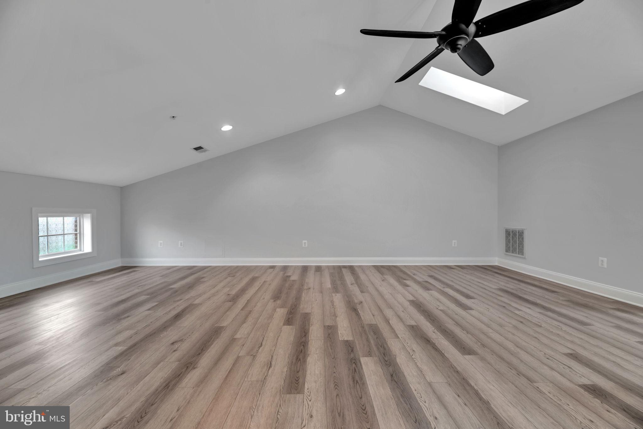 7619 Elmcrest Road Hanover, MD 21076 - Photo 23 of 35 an empty room with wooden floor and windows