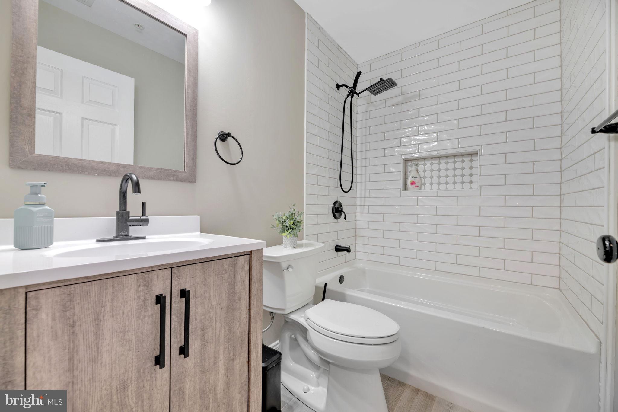 7619 Elmcrest Road Hanover, MD 21076 - Photo 26 of 35 a bathroom with a sink a toilet and shower