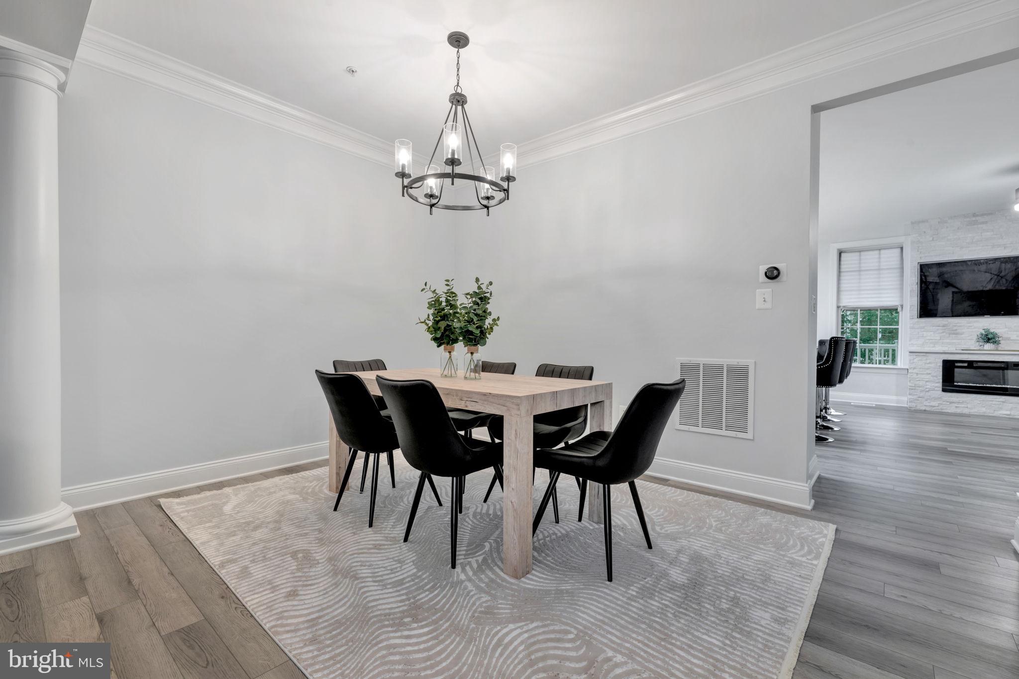7619 Elmcrest Road Hanover, MD 21076 - Photo 10 of 35 a view of a dining room with furniture wooden floor and a chandelier