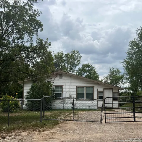 a view of a barn in the middle of a yard