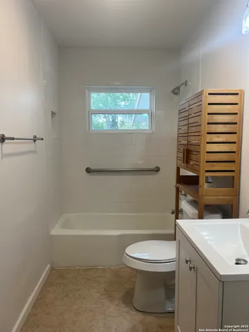 a bathroom with a toilet a sink and bathtub