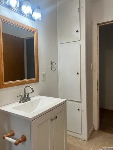 a bathroom with a sink and a mirror