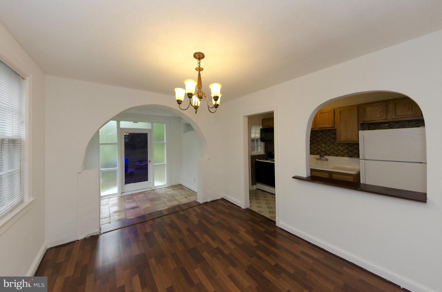 2016 North Troy Street Arlington, VA 22201 - Photo 6 of 25 a view of a hallway with wooden floor and chandelier