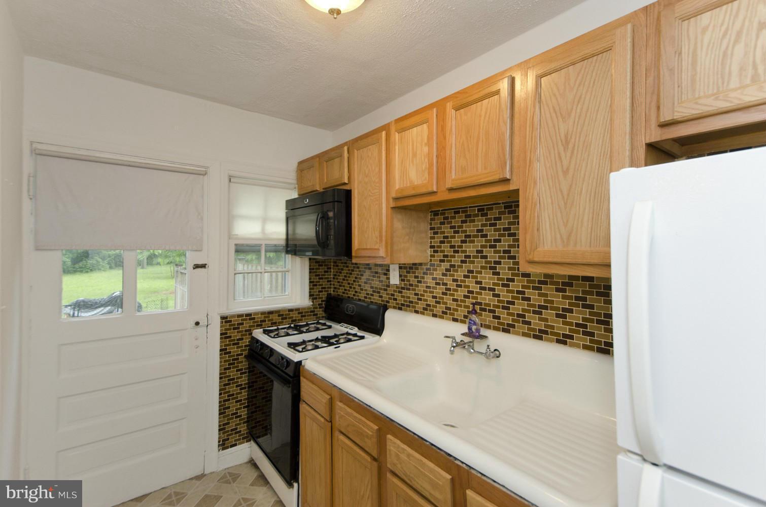 2016 North Troy Street Arlington, VA 22201 - Photo 9 of 25 a kitchen with a sink stove and refrigerator