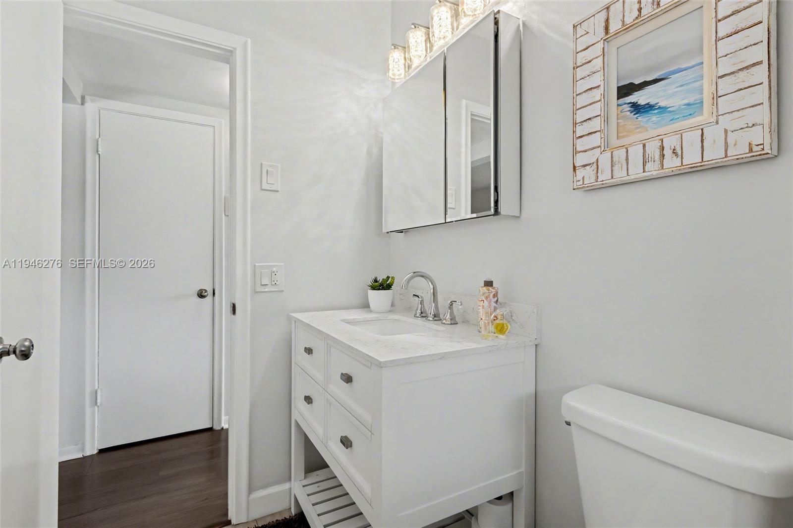 412 South Cypress Road, Unit 222 Pompano Beach, FL 33060 - Photo 16 of 24 a bathroom with a sink toilet and vanity