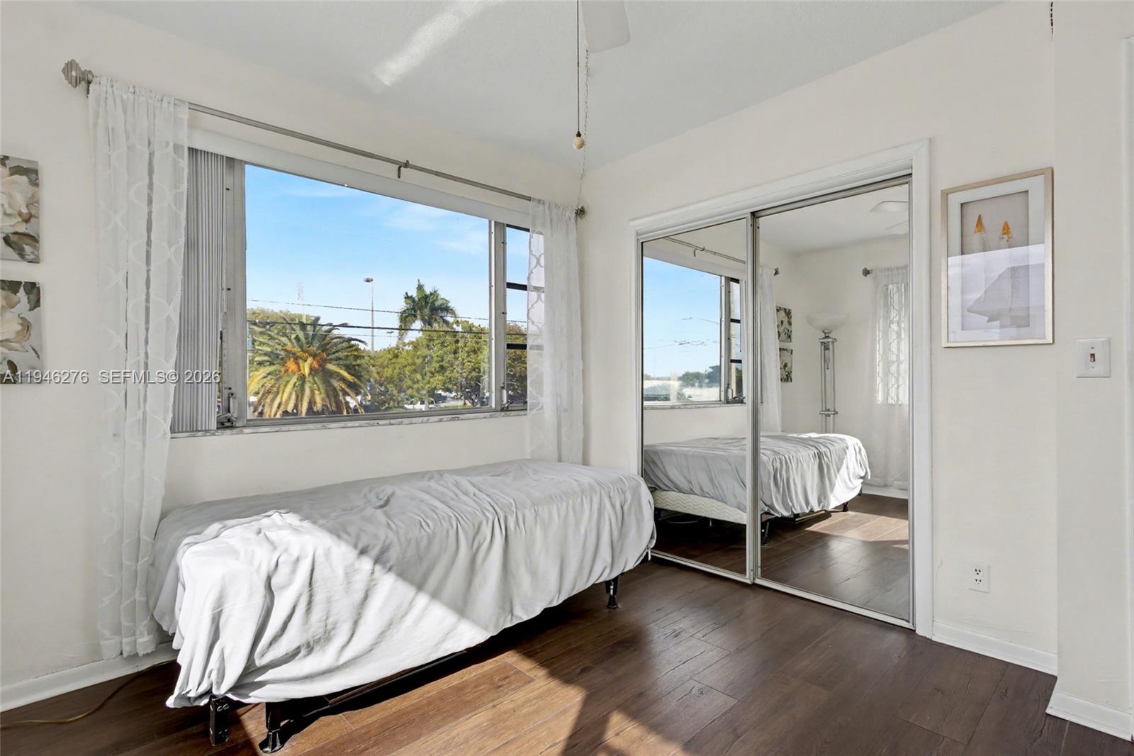 412 South Cypress Road, Unit 222 Pompano Beach, FL 33060 - Photo 17 of 24 a living room with a bed furniture and a window