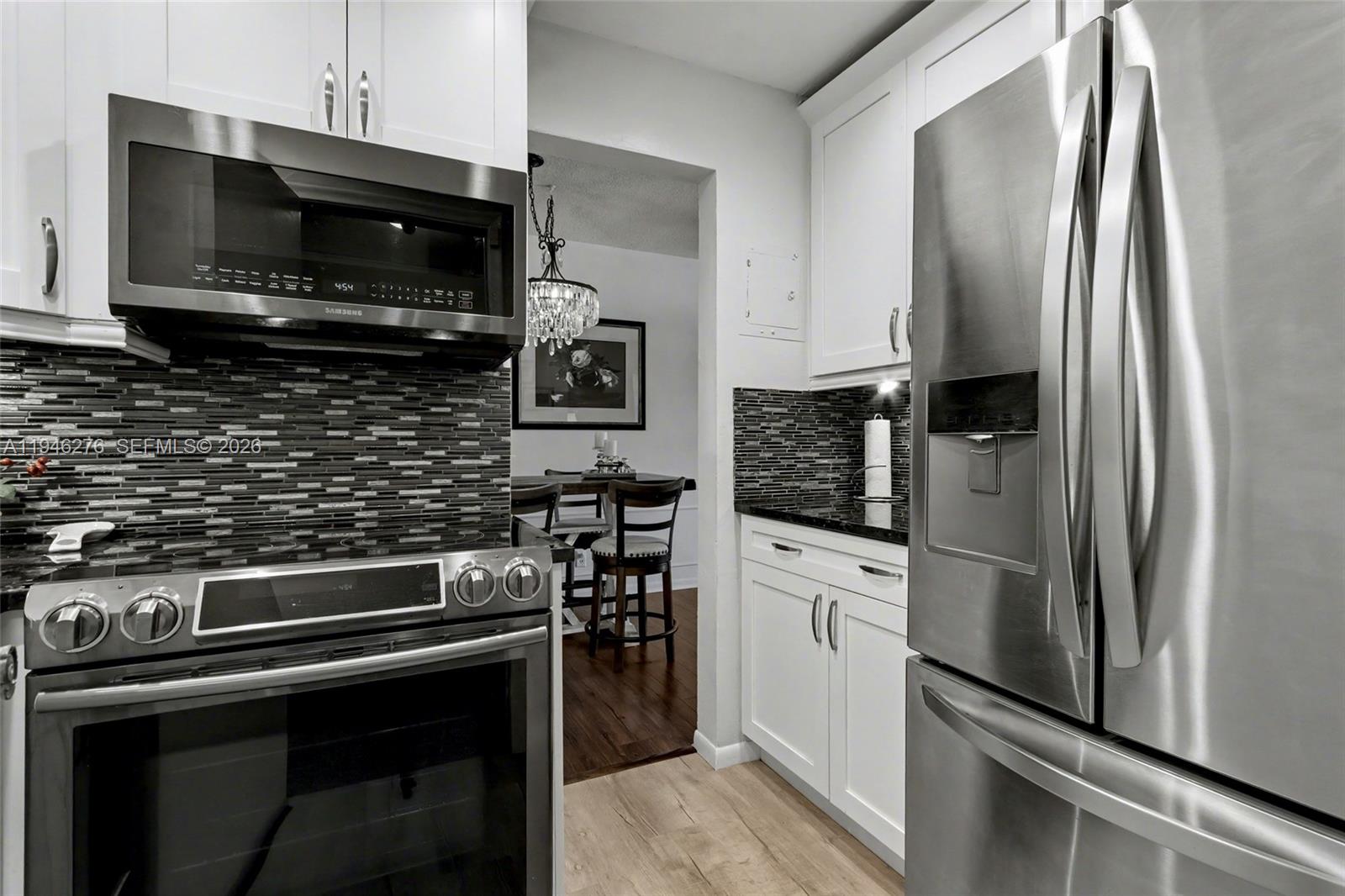 412 South Cypress Road, Unit 222 Pompano Beach, FL 33060 - Photo 4 of 24 a kitchen with a refrigerator stove and microwave