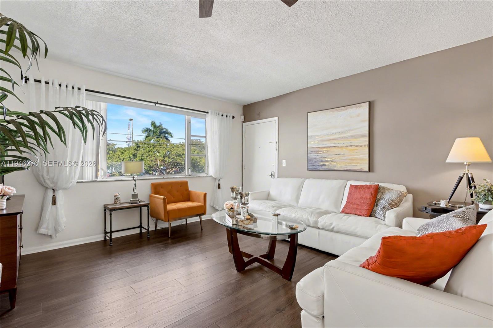 412 South Cypress Road, Unit 222 Pompano Beach, FL 33060 - Photo 8 of 24 a living room with furniture and a large window