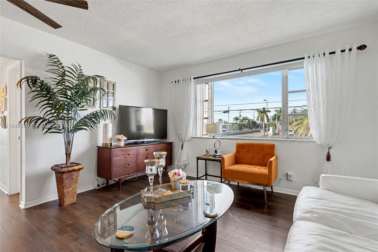 412 South Cypress Road, Unit 222 Pompano Beach, FL 33060 - Photo 9 of 24 a living room with furniture and a potted plant
