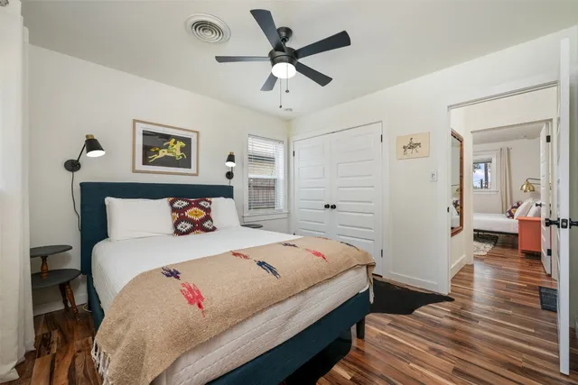 a bedroom with a bed and a chandelier