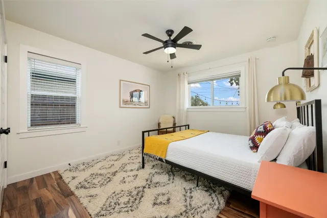 a bedroom with a bed and wooden floor