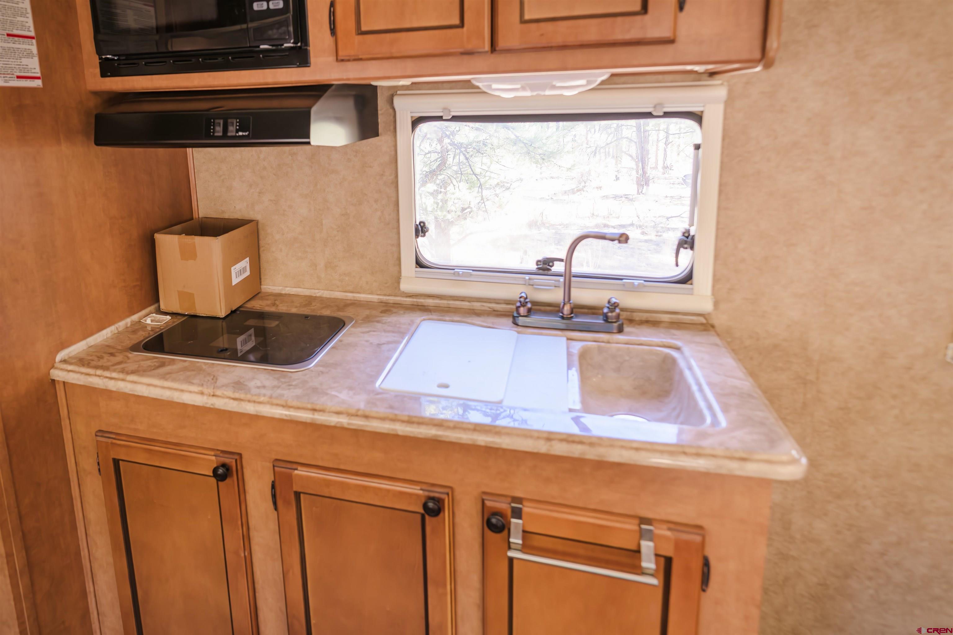 17990 Kings Road Weston, CO 81091 - Photo 31 of 45 a kitchen with a sink cabinets and a window