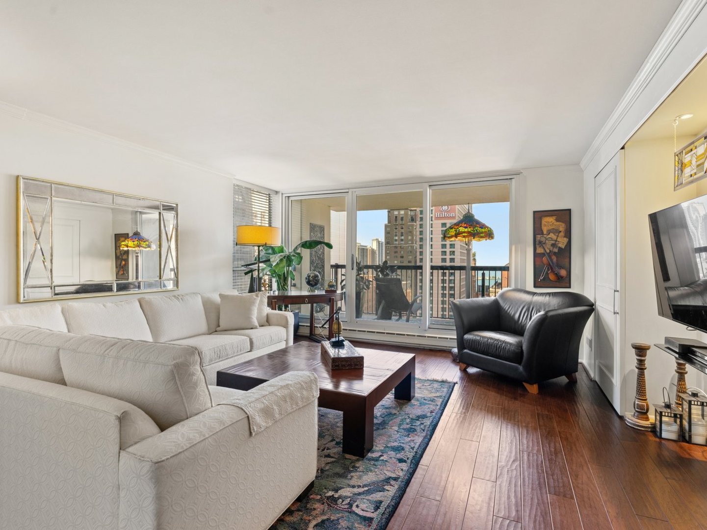 201 East Chestnut Street, Unit 23A Chicago, IL 60611 - Photo 5 of 21 a living room with furniture and a flat screen tv