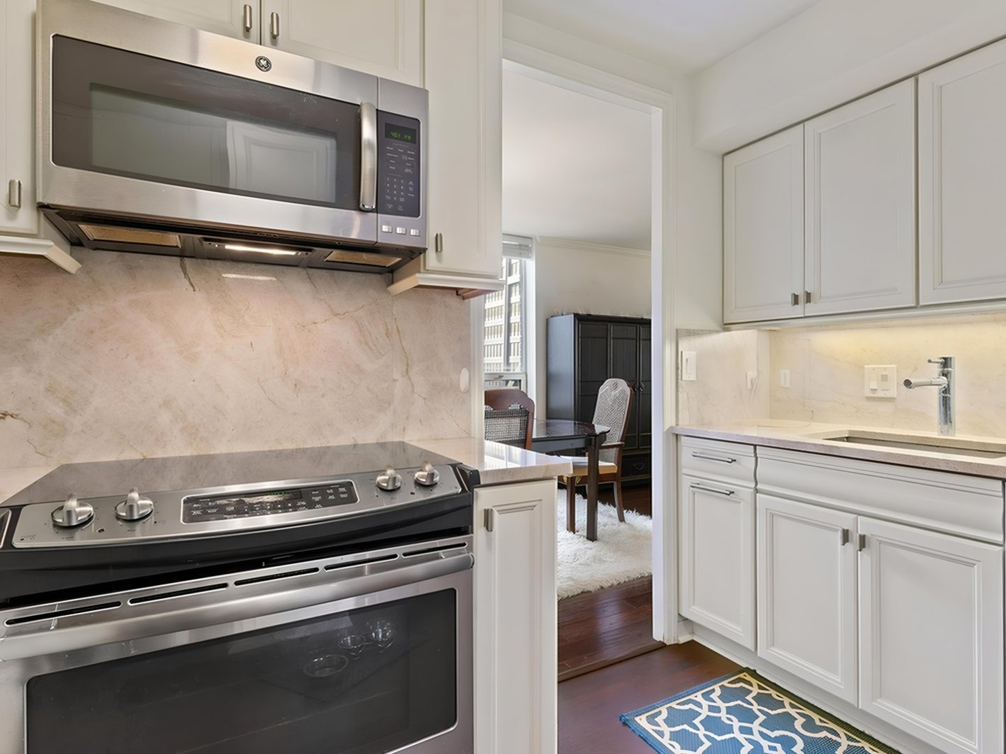 201 East Chestnut Street, Unit 23A Chicago, IL 60611 - Photo 8 of 21 a kitchen with a stove and a microwave
