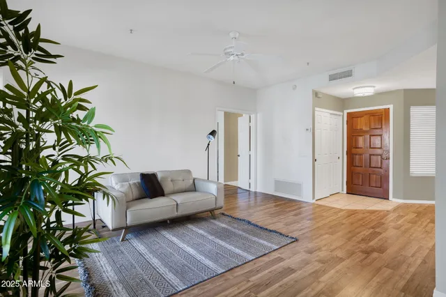 a living room with furniture and a large window