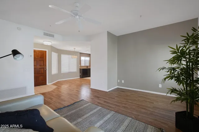 a living room with furniture and a potted plant