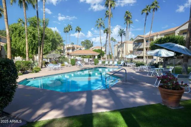 a swimming pool with outdoor seating and yard