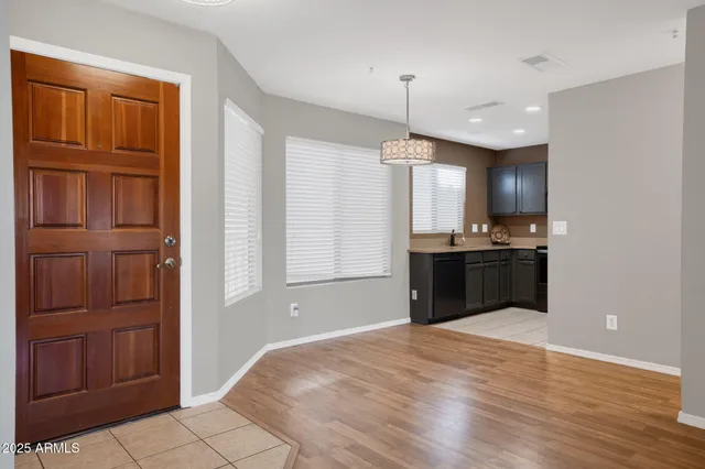 a kitchen with kitchen island granite countertop wooden cabinets and white appliances