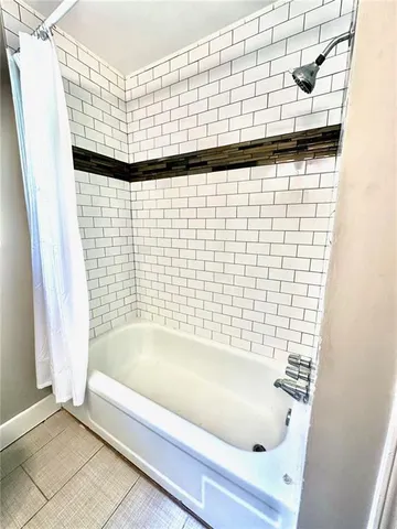 a bathroom with a bathtub and shower