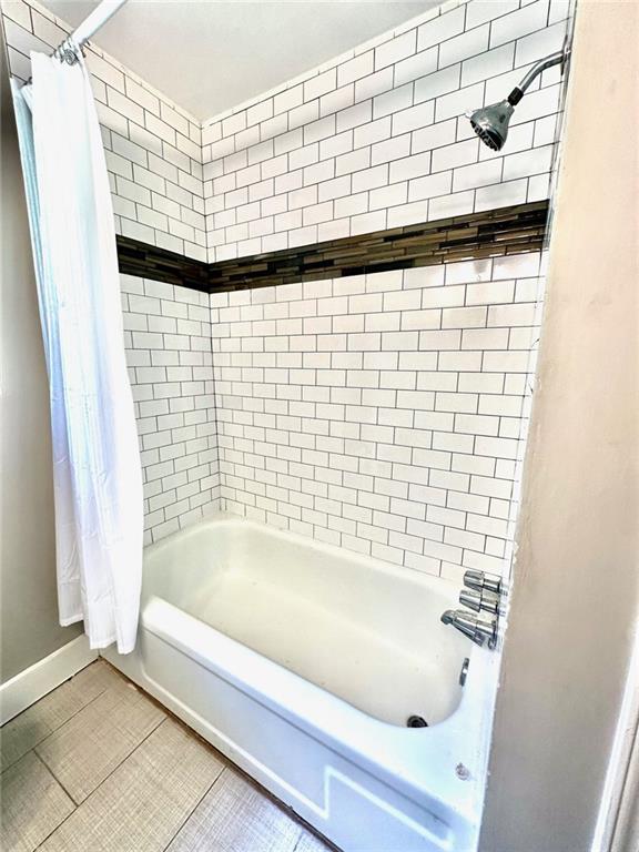 1726 Fairburn Road Southwest Atlanta, GA 30331 - Photo 11 of 12 a bathroom with a bathtub and shower