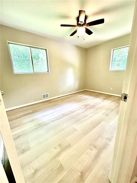 1726 Fairburn Road Southwest Atlanta, GA 30331 - Photo 12 of 12 a view of a room with a ceiling fan and a window