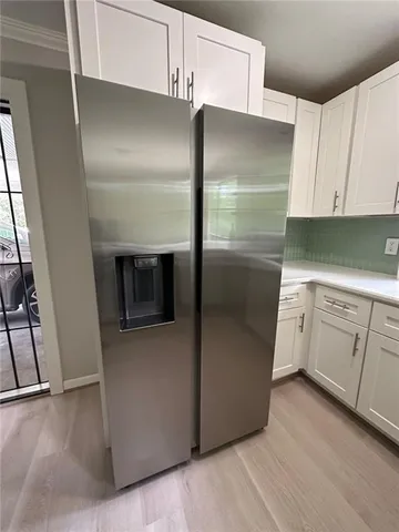 a kitchen with stainless steel appliances a refrigerator and a stove top oven