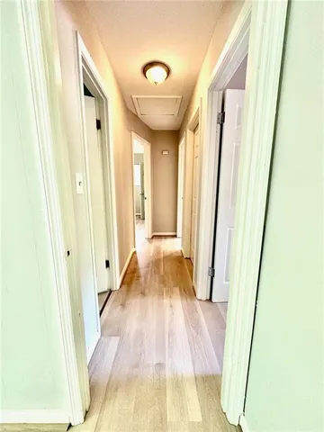 a view of a hallway with wooden floor