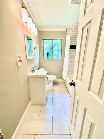 a bathroom with a sink toilet and window