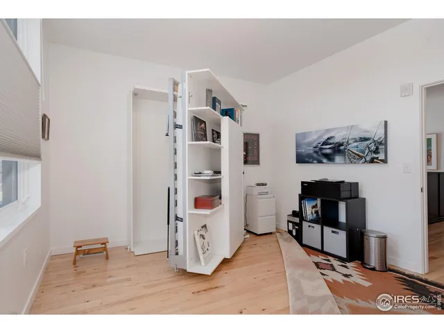 a bedroom with a bed and a bookshelf