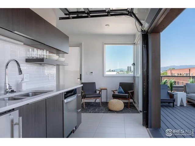 a roof deck with a table and chairs