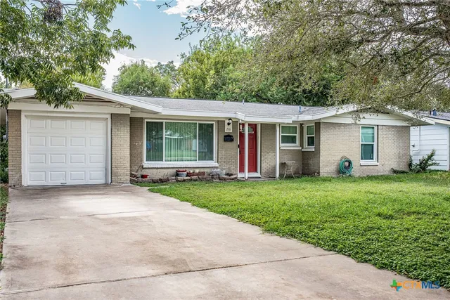 a view of a house with yard and a garden