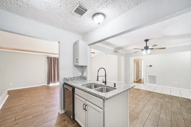 a kitchen with a sink and a refrigerator