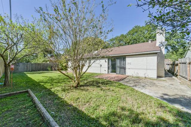 a view of backyard of house with green space