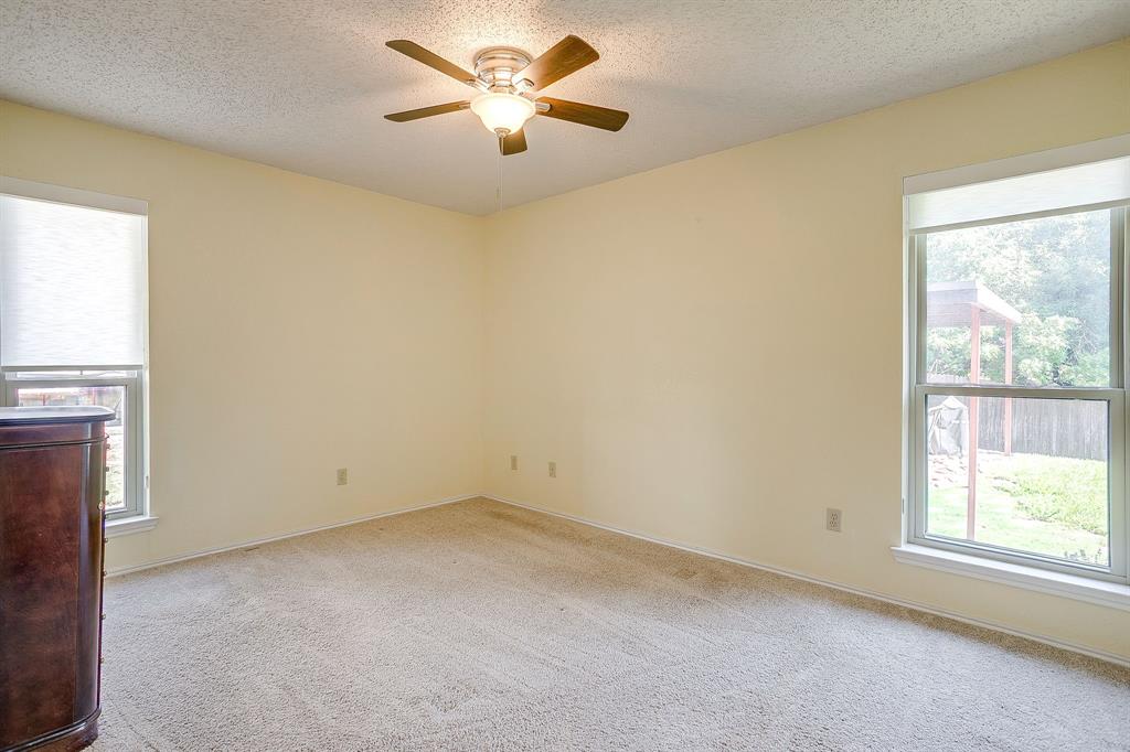 1116 Highpoint Road Bedford, TX 76022 - Photo 27 of 37 Unfurnished room featuring a textured ceiling, light colored carpet, and ceiling fan