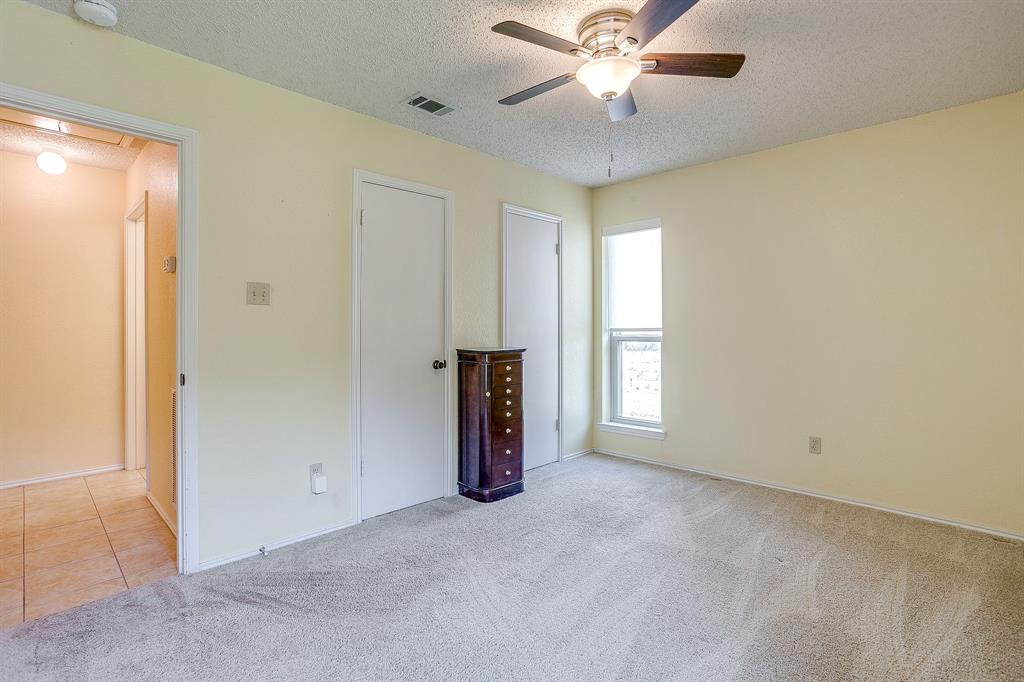 1116 Highpoint Road Bedford, TX 76022 - Photo 28 of 37 Unfurnished bedroom with carpet flooring, a textured ceiling, and a ceiling fan