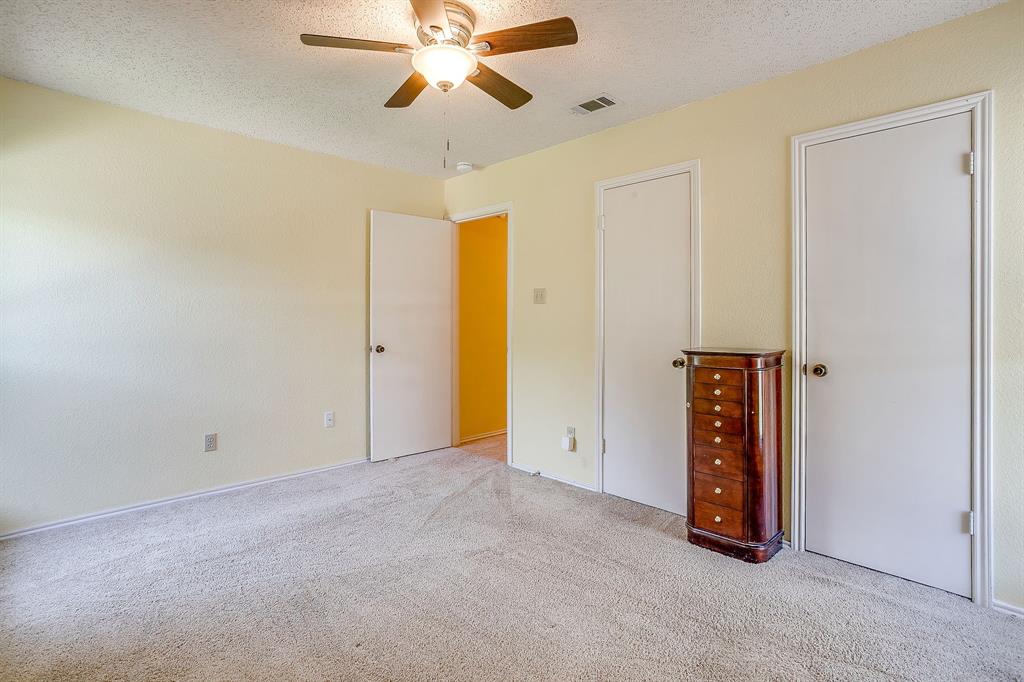 1116 Highpoint Road Bedford, TX 76022 - Photo 29 of 37 Unfurnished bedroom with a textured ceiling, carpet flooring, and a ceiling fan