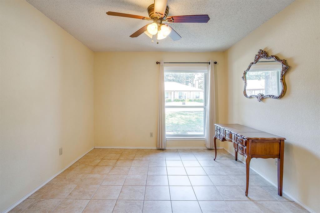 1116 Highpoint Road Bedford, TX 76022 - Photo 3 of 37 Doorway featuring a textured ceiling, tile patterned flooring, and ceiling fan