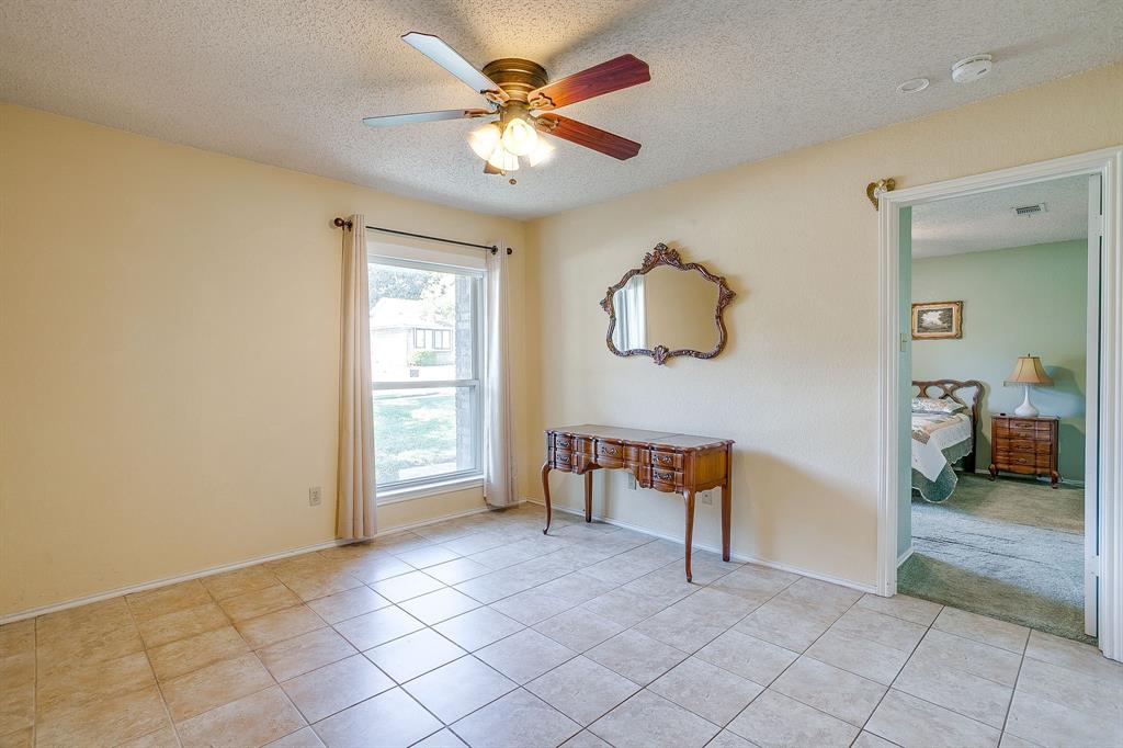 1116 Highpoint Road Bedford, TX 76022 - Photo 4 of 37 Unfurnished room with a textured ceiling, light tile patterned floors, and ceiling fan