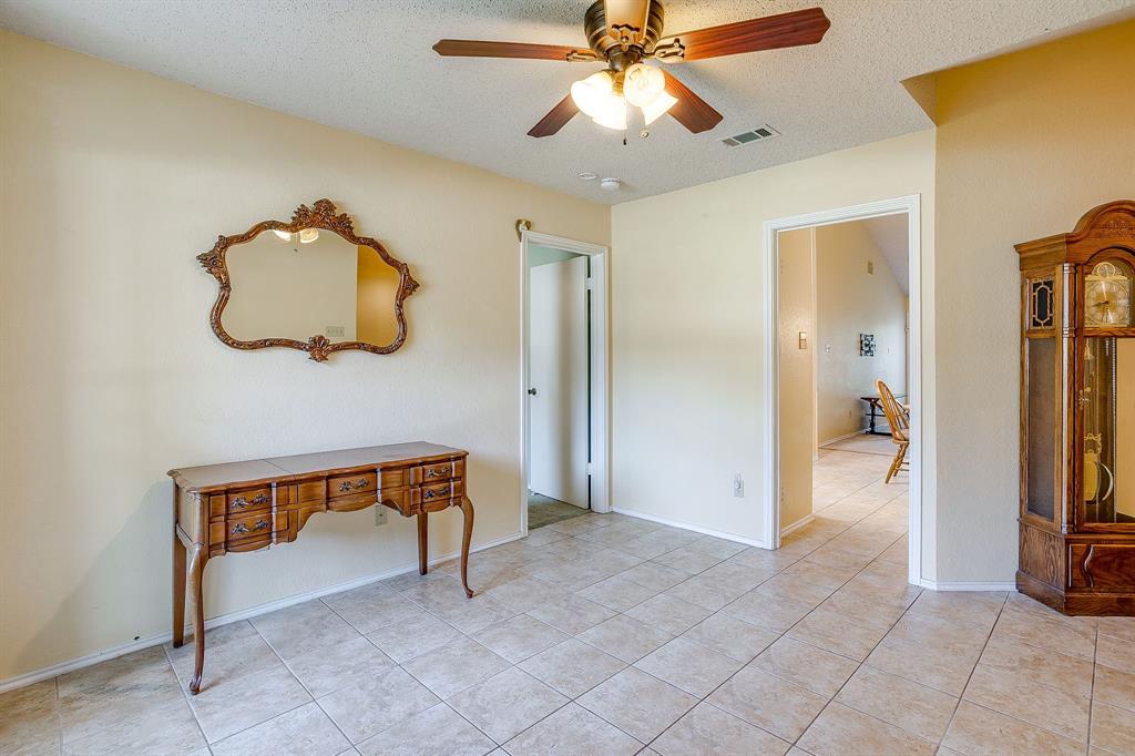 1116 Highpoint Road Bedford, TX 76022 - Photo 5 of 37 Tiled bedroom with a ceiling fan and a textured ceiling