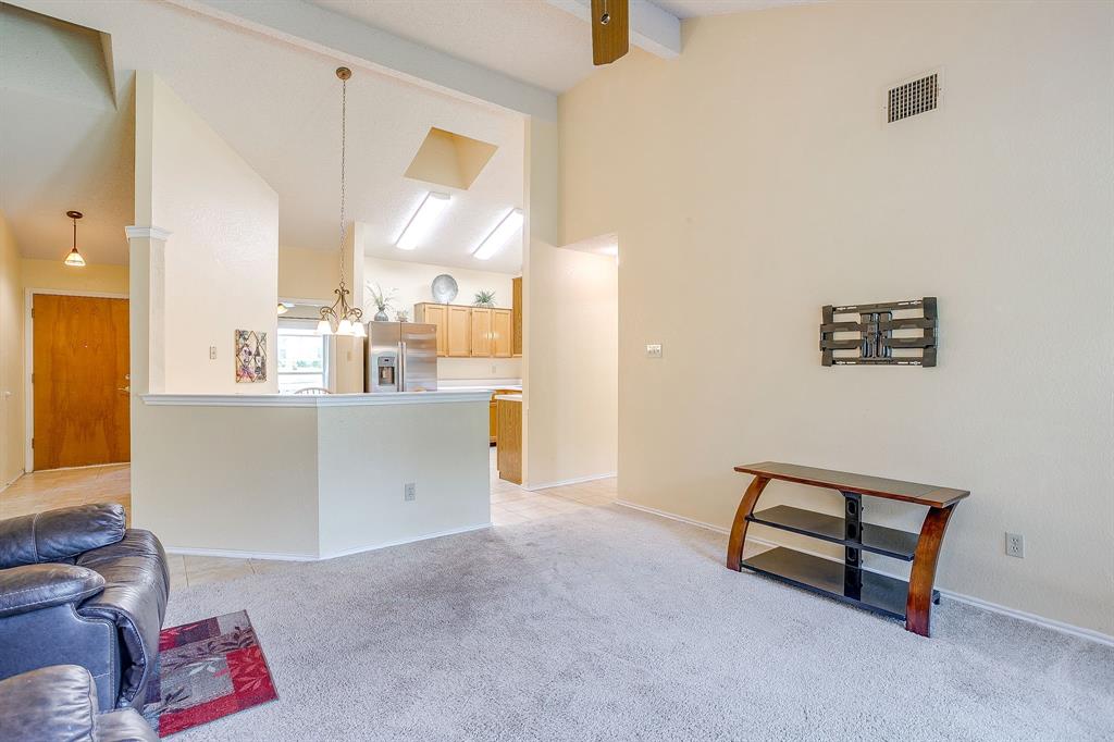1116 Highpoint Road Bedford, TX 76022 - Photo 10 of 37 Living room featuring beam ceiling, high vaulted ceiling, light colored carpet, and light tile patterned floors