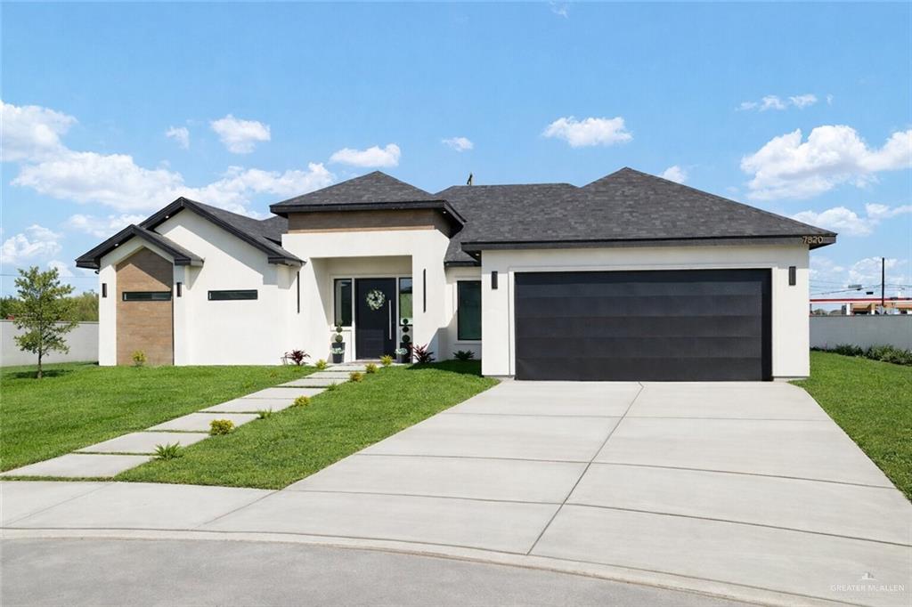 7820 North 38th Street McAllen, TX 78504 - Photo 1 of 31 Prairie-style home featuring a garage, concrete driveway, stucco siding, and roof with shingles