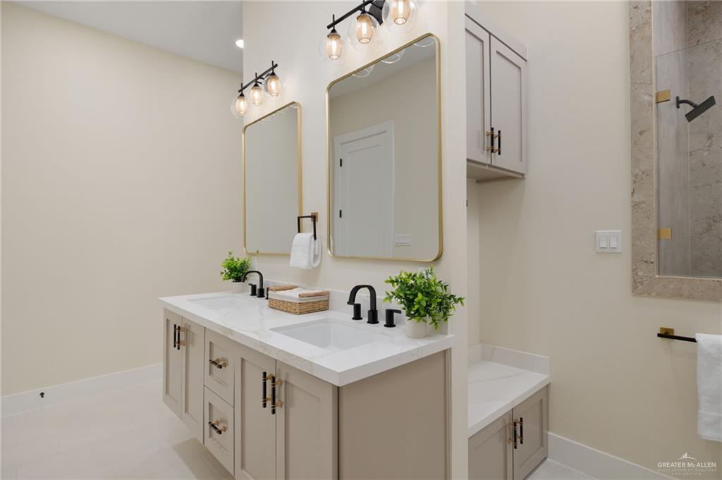 7820 North 38th Street McAllen, TX 78504 - Photo 16 of 31 Full bathroom with double vanity and baseboards