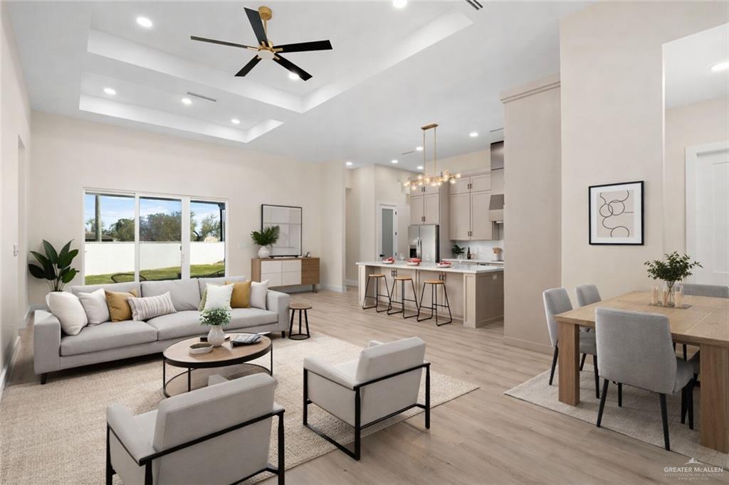 7820 North 38th Street McAllen, TX 78504 - Photo 2 of 31 Living room with light wood-style floors, a towering ceiling, a chandelier, recessed lighting, and a ceiling fan