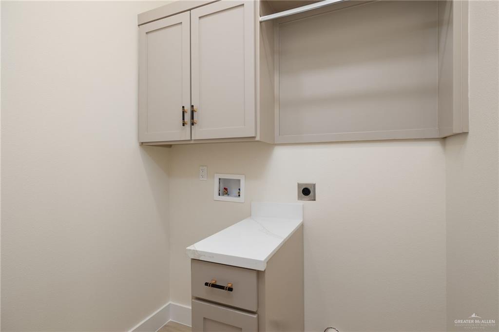 7820 North 38th Street McAllen, TX 78504 - Photo 28 of 31 Laundry area featuring hookup for a washing machine, hookup for an electric dryer, and cabinet space