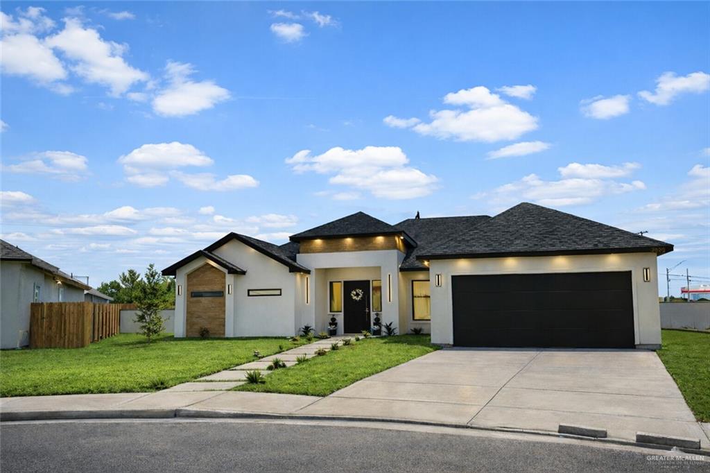 7820 North 38th Street McAllen, TX 78504 - Photo 31 of 31 View of front of house with stucco siding, an attached garage, concrete driveway, and roof with shingles