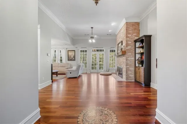 a living room with furniture a flat screen tv and kitchen view